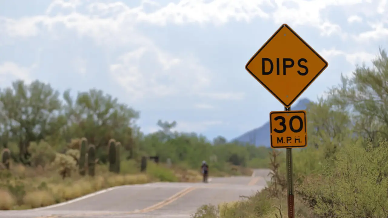speed hump or sharp dip road sign